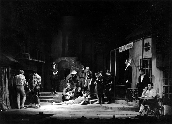 Garry O'Connor plays the guitar, Ian McKellen dies, tall Simon Relph watches and Richard Cottrell, sitting, plays out front in ''Camino Real'', ADC 1958